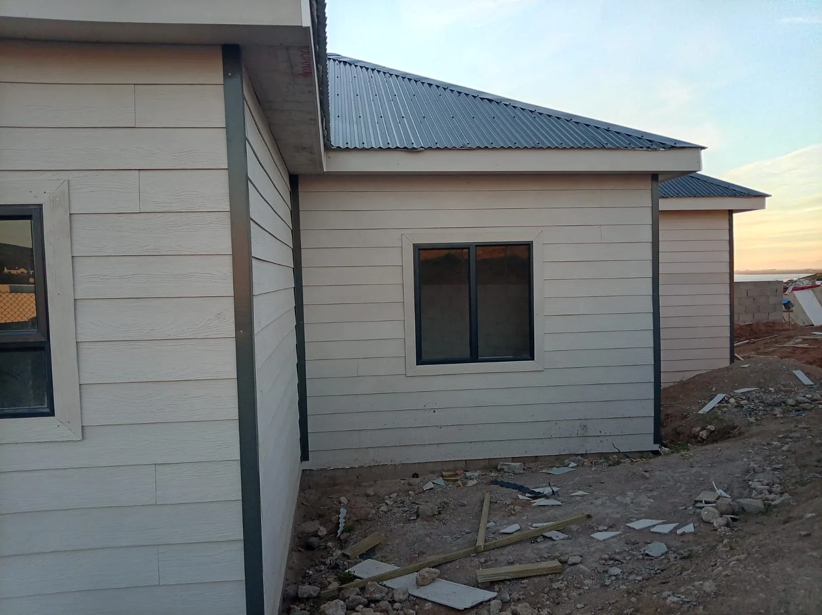 Completed fibre-cement wing with metal roof