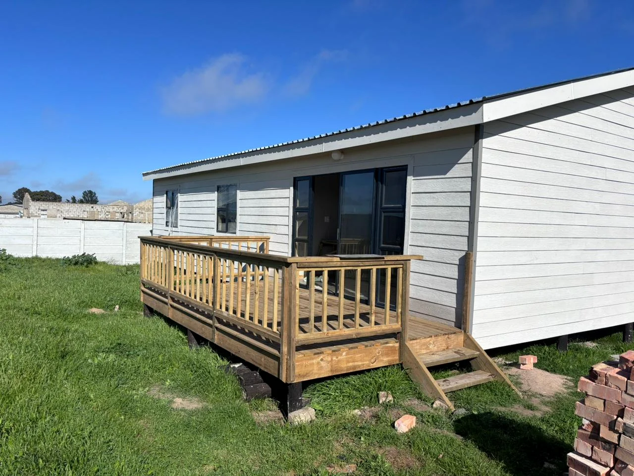 Completed Nutec-style home with timber deck