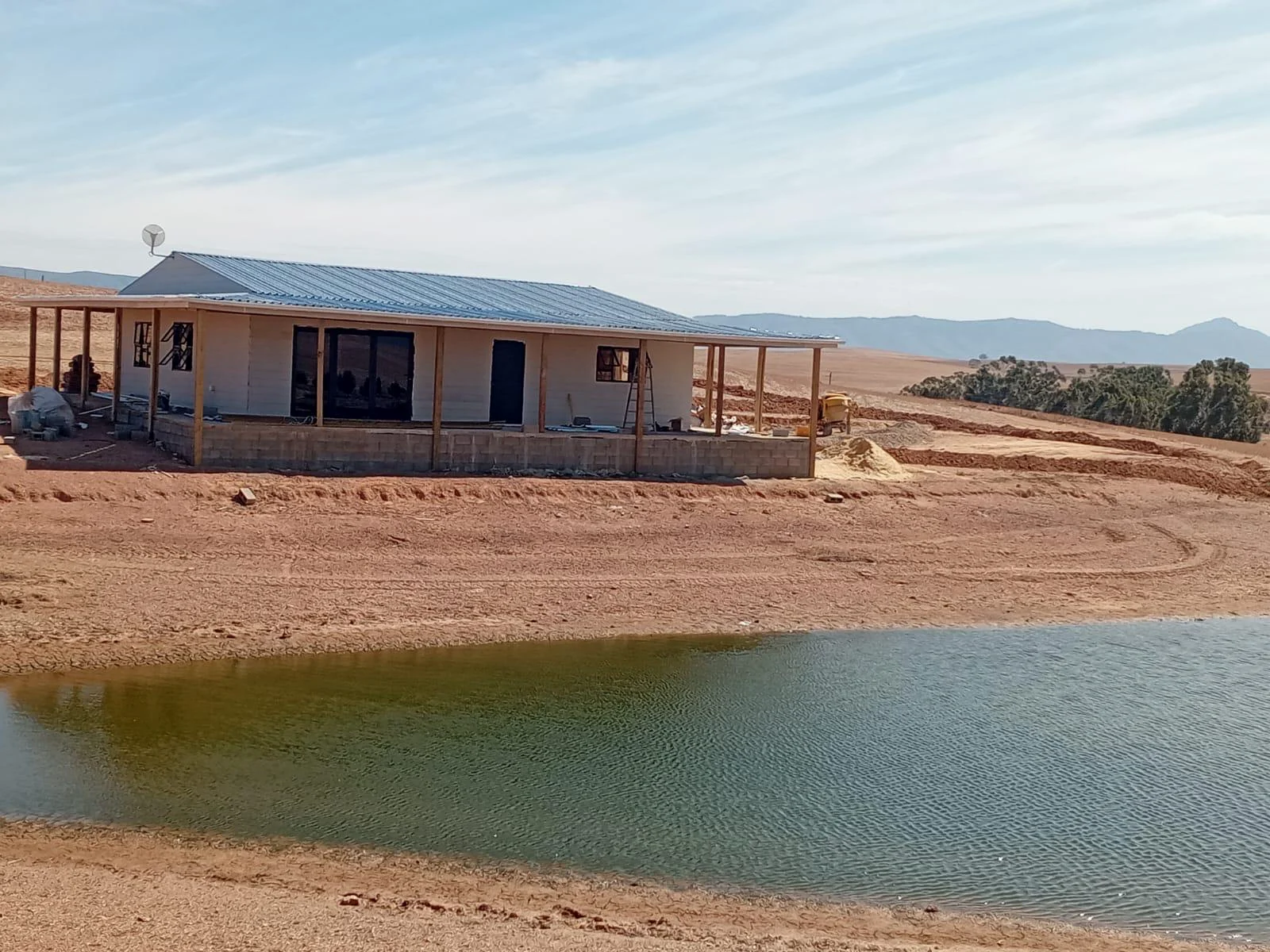 Long completed fibre-cement home in open landscape